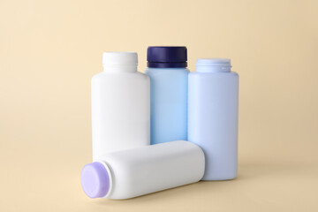 Baby powder in bottles on beige background. Space for text