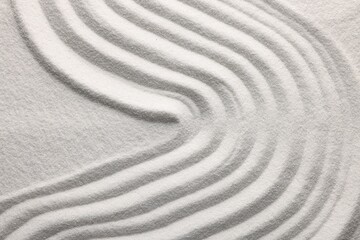 Fototapeta na wymiar Pattern drawn on white sand, above view. Zen garden