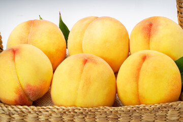 Yellow Peach with sliced on white Background, Fresh peach in wooden basket on white Background.