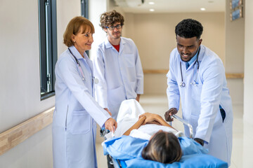 Group of professional medical doctor team and assistant with stethoscope in uniform taking seriously injured coma patient to operation emergency theatre room in hospital.health medical care concept
