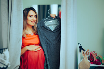 Pregnant Woman in a Store Dressing Room Holding Maternity Dress.Mother to be changing her wardrobe...