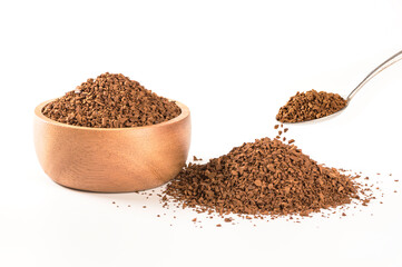 Instant coffee granules in wooden bowl and spoon isolated on white background.