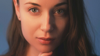 Fototapeta premium Skin wellness. Facelift procedure. Natural beauty care. Attractive young calm woman with smooth perfect radiant skin with nude makeup on grey background.
