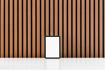 Phone, Tablet and Notebook against wood slat wall