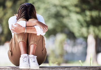 Sad, cry and student with woman in park for depression, frustrated and stress. Mental health,...