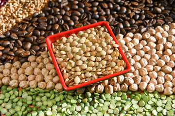Bowl with raw white lentils on various seeds grain