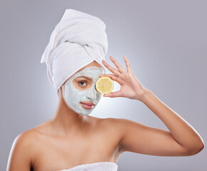 Mask, skincare and lemon with portrait of woman in studio for beauty, natural cosmetics and vitamin c. Self care, glow and spa with female model and citrus fruit on grey background for detox product