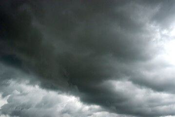 Dramatic dark storm thundercloud rain clouds on black sky background. Dark thunderstorm clouds...