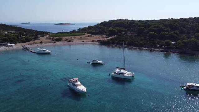 Boats and Yachts of Various types anchored in Turquoise clear water of Blue Lagoon Bay at Veliki Budikovac Island, Croatia. Aerial