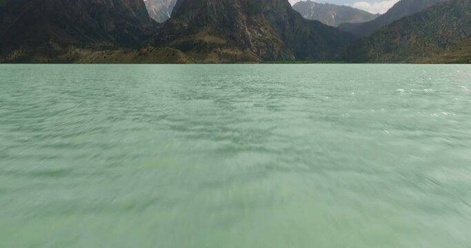 Flying over Iskander Kul Lake in Tajikistan towards the mountains - Aerial