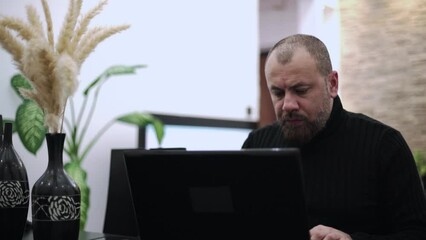 A worried man on the phone in the living room