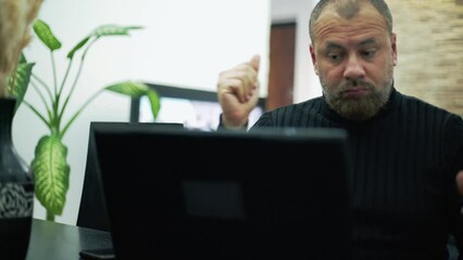 A worried man on the phone in the living room