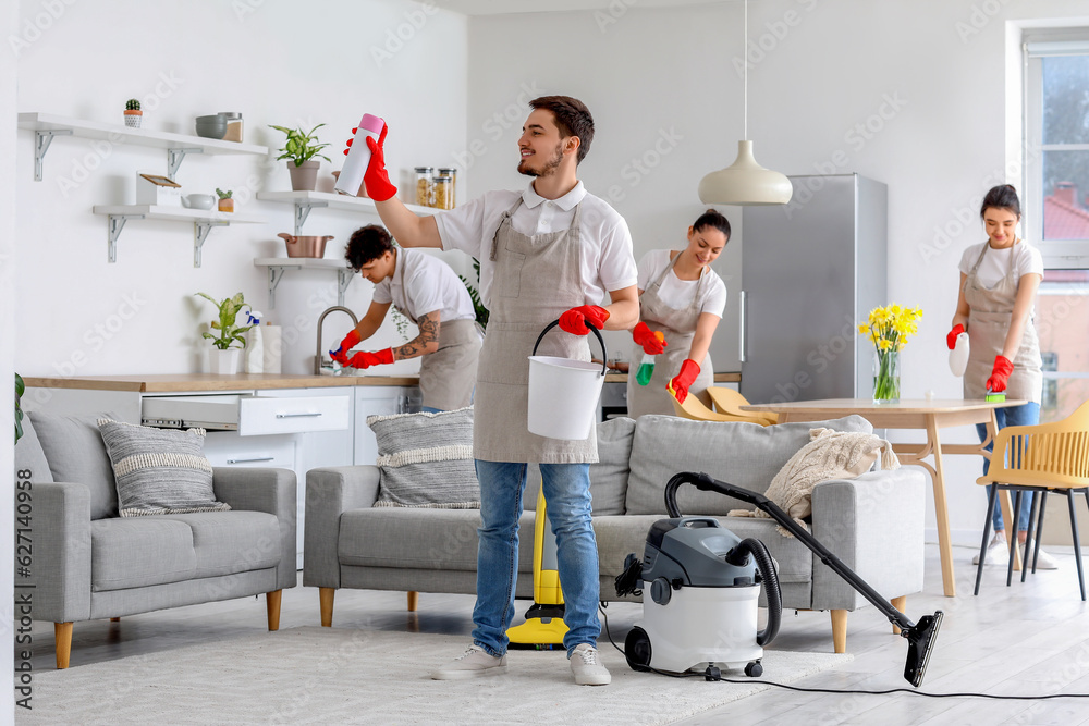 Poster Young janitors cleaning in kitchen