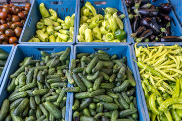 Pickles and different kinds of pepper for sale at a market