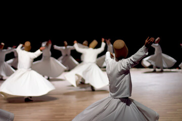 Dervishes perform on the stage for Mevlana