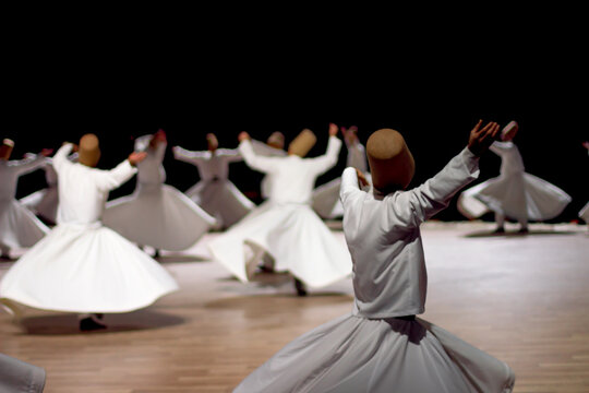 Dervishes perform on the stage for Mevlana
