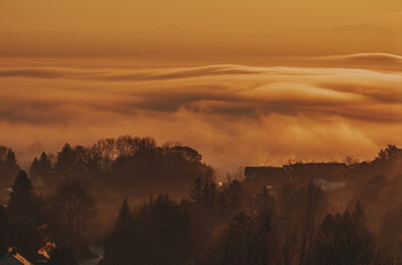 cloudy sky in the austrian morning sun with orange sunlight