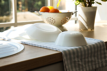Clean bowls on wooden kitchen counter, closeup