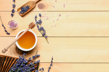 Fototapeta na wymiar Bowl of sweet lavender honey, dipper and flowers on wooden background