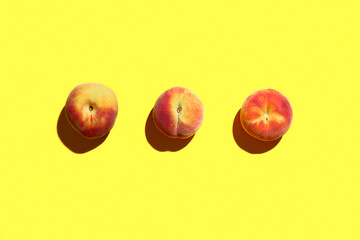 Sweet peaches on yellow background