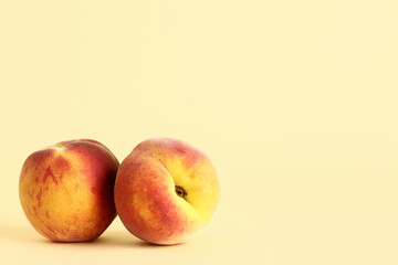 Sweet peaches on yellow background