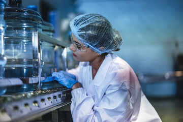 Inspector check conveyor operation with precise bottled water sequencing for seamless production.