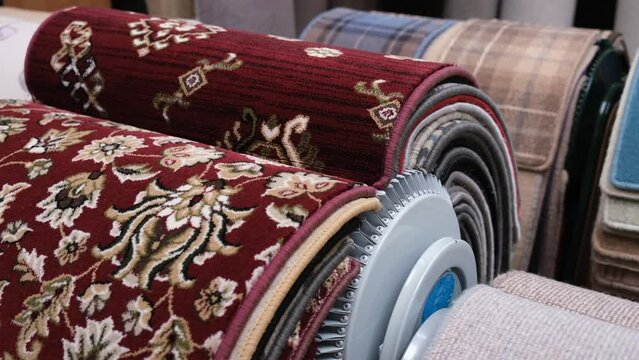 Customer looks through some carpet samples in a carpet shop