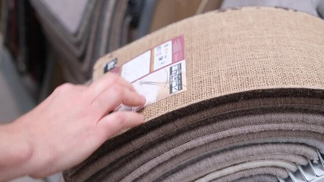 Customer looks through carpet samples in a carpet shop