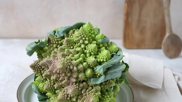 Romanesco broccoli on plate on kitcen table, front view. 