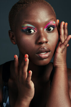 Youre always on fleek if youre wearing color. Cropped shot of a beautiful woman wearing colorful eyeshadow while posing against a grey background.