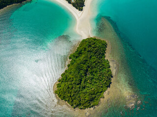 Aerial view of island with sandy beach and turquoise water. Kelambu Beach. Borneo, Malaysia.
