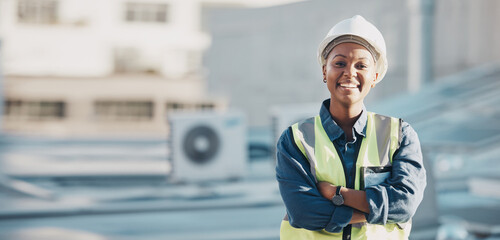 Woman, construction worker and portrait with a smile for engineering and building renovation job. Arms crossed, happy and African female employee on a industrial site outdoor for builder project - obrazy, fototapety, plakaty