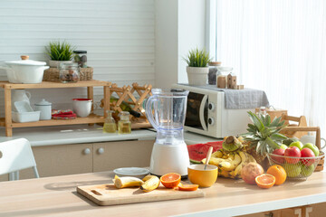 Variety of fruits are placed on the table to make healthy smoothies, modern kitchen with fruits on wooden table