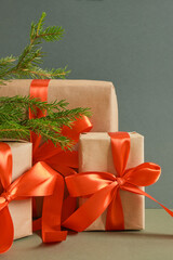 gift boxes with red ribbons on a green background, craft decorations and gifts