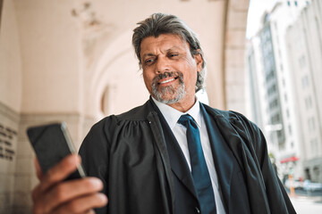 Phone, app and a senior man judge at court, outdoor in the city during recess from a legal case or...