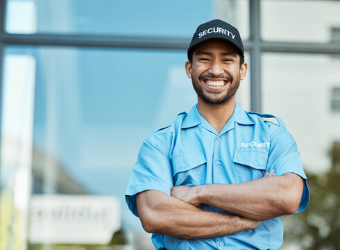 Happy man, portrait and security guard with arms crossed in city for career safety or outdoor protection. Male person, police or officer smile in confidence, law enforcement or patrol in urban town