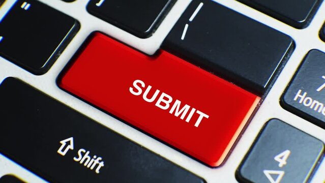 Laptop Keyboard Close Up and Finger Press Submit Word or Text Button Key