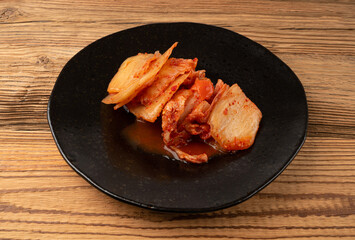 Kimchi Isolated, Kimchee on Black Plate, Red Spicy Kim Chi, Hot Fermented Napa Cabbage