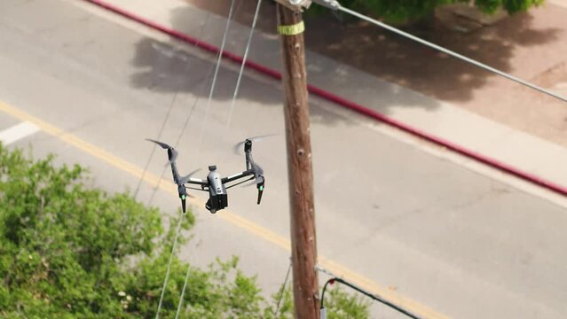 Drone inspecting power lines, distribution lines