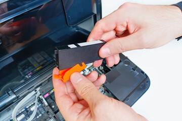 Removing Plastic Cap from the Ink Nozzle of a Printer Cartridge