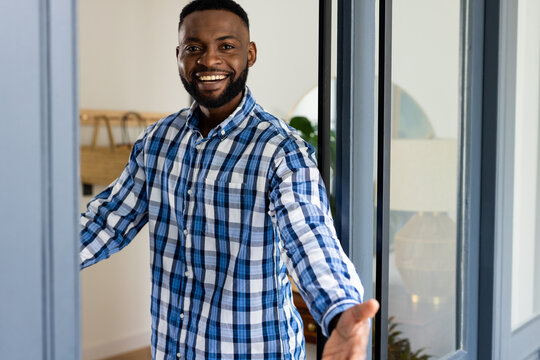 Portrait Of Happy African American Man In Front Door At Home