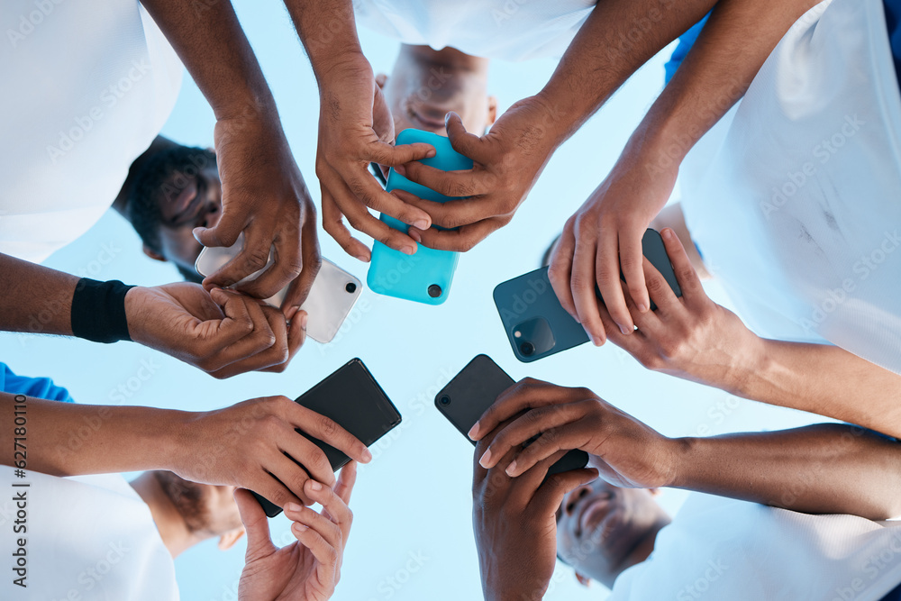 Aufkleber Hands, phone and app with people in a huddle or circle for communication or connectivity. Mobile, social media or information sharing with a group of men networking together closeup from below