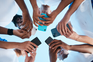 Hands, phone and app with people in a huddle or circle for communication or connectivity. Mobile,...