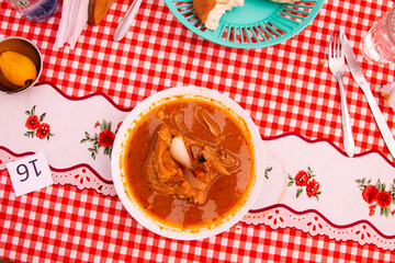 The Adobo de Chancho arequipeño consists of a marinated pork meat dish that is accompanied by...