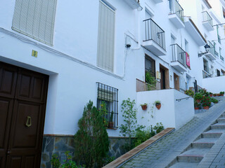 Facades of houses in the white village Tolox in Andalusia