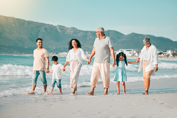 Generations, holding hands and walking family on beach and ocean waves, freedom and bonding in...