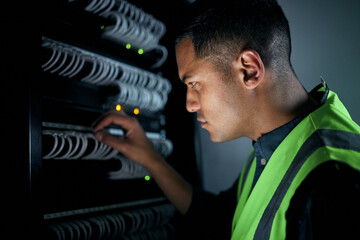 Fototapeta na wymiar Technician man, server room and inspection for cables, thinking and focus for analysis, night and programming. Information technology engineer, maintenance and database with problem solving mindset