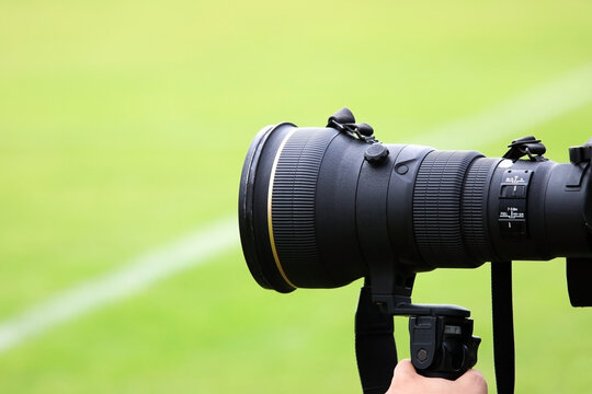 The telephoto lens of a camera used in sporting events.