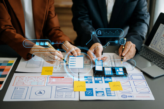  UX developer and ui designer brainstorming about mobile app interface wireframe design with customer breif and color code at modern office. on virtual  screen. .