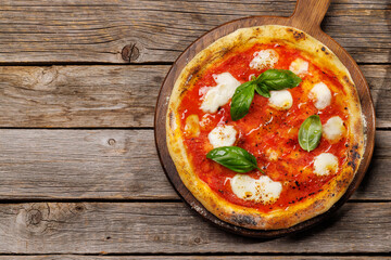 Margarita pizza with tomatoes, mozzarella cheese and basil